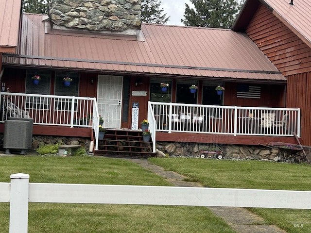 170 Red Fir Rd, Kooskia, ID 83539 - view of front facade with a porch, metal roof, and a front yard