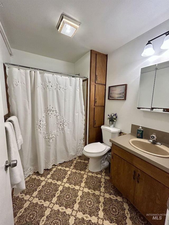 170 Red Fir Rd, Kooskia, ID 83539 - full bath with vanity, toilet, a shower with shower curtain, and tile patterned floors