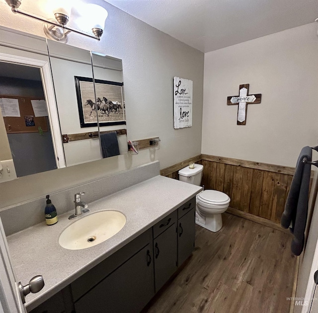 170 Red Fir Rd, Kooskia, ID 83539 - bathroom with wood finished floors, a wainscoted wall, toilet, vanity, and wood walls