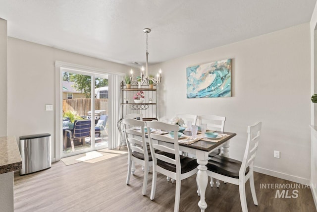 4249 W Farlam Dr, Meridian, ID 83642 - dining space featuring light wood-style flooring, a chandelier, and baseboards