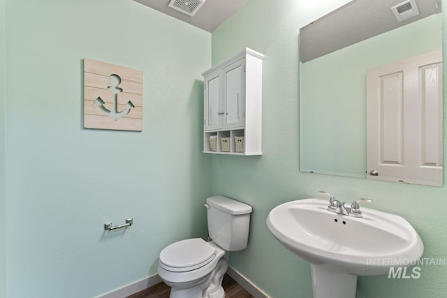 4249 W Farlam Dr, Meridian, ID 83642 - bathroom with toilet, wood finished floors, a sink, and baseboards