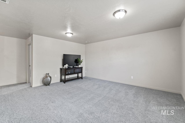 4249 W Farlam Dr, Meridian, ID 83642 - carpeted living area featuring baseboards and a textured ceiling