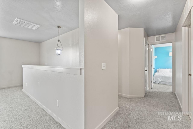 4249 W Farlam Dr, Meridian, ID 83642 - hall with carpet, baseboards, a textured ceiling, and an upstairs landing