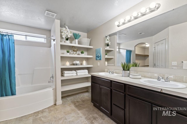 4249 W Farlam Dr, Meridian, ID 83642 - bathroom featuring shower / tub combo with curtain, double vanity, and a textured ceiling
