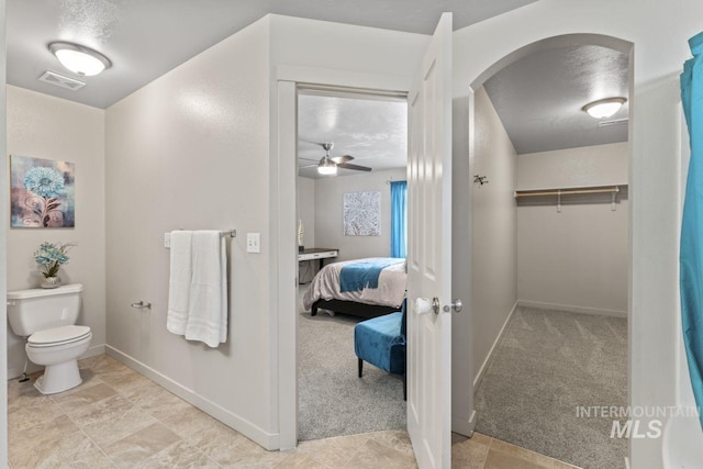 4249 W Farlam Dr, Meridian, ID 83642 - ensuite bathroom with baseboards, toilet, a walk in closet, and ceiling fan