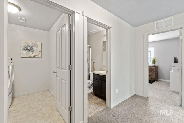 4249 W Farlam Dr, Meridian, ID 83642 - hall featuring light colored carpet, baseboards, and washer / clothes dryer