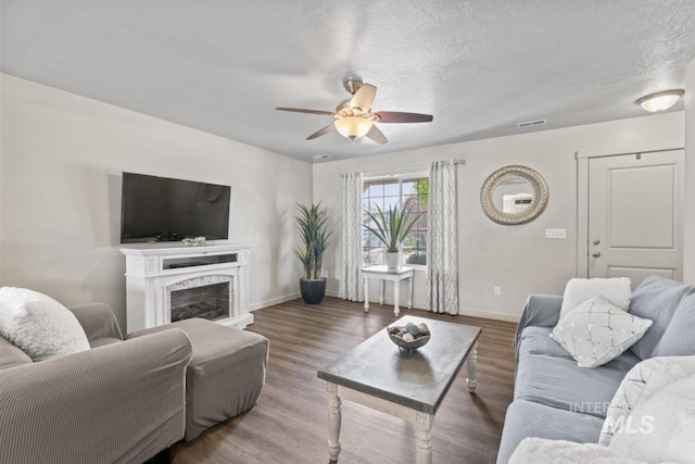 4249 W Farlam Dr, Meridian, ID 83642 - living room with ceiling fan, baseboards, wood finished floors, a fireplace, and a textured ceiling