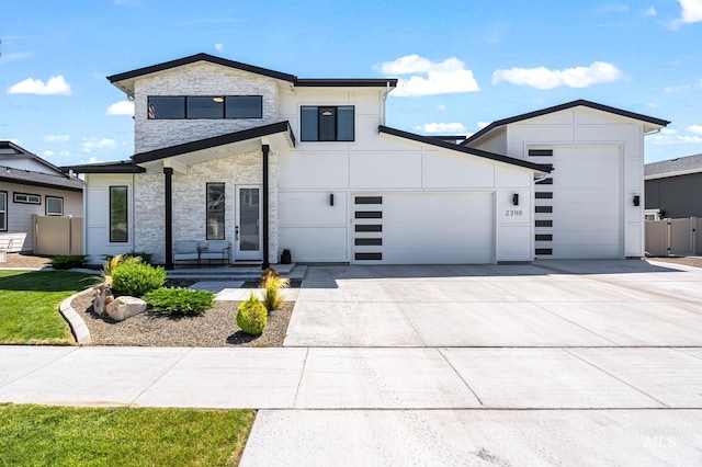 2398 N Klemmer Ave, Kuna, ID 83634 - contemporary home featuring stone siding, a garage, and concrete driveway