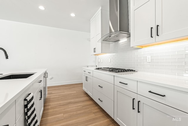 2398 N Klemmer Ave, Kuna, ID 83634 - kitchen featuring wall chimney exhaust hood, stainless steel gas stovetop, backsplash, light countertops, and recessed lighting