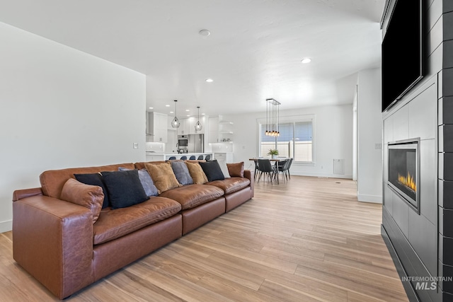 2398 N Klemmer Ave, Kuna, ID 83634 - living area with light wood finished floors, a glass covered fireplace, and recessed lighting
