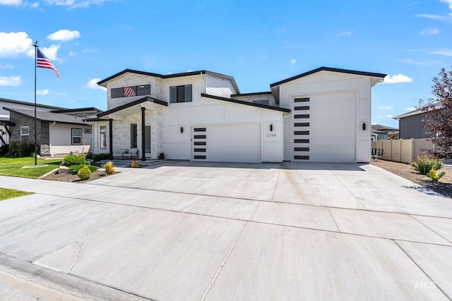 2398 N Klemmer Ave, Kuna, ID 83634 - contemporary house with an attached garage, stone siding, and driveway