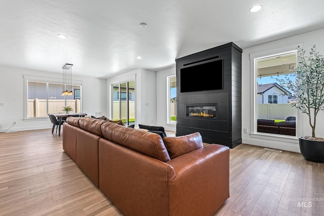 2398 N Klemmer Ave, Kuna, ID 83634 - living room featuring a fireplace, light wood finished floors, plenty of natural light, and recessed lighting