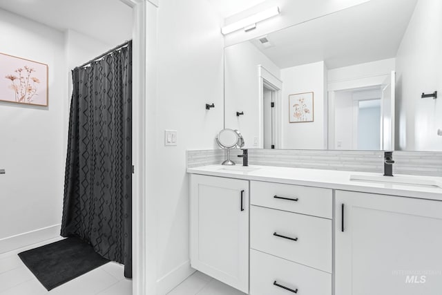 2398 N Klemmer Ave, Kuna, ID 83634 - full bathroom with double vanity, tile patterned floors, and a shower with shower curtain