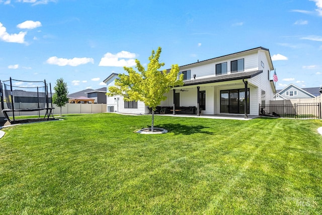 2398 N Klemmer Ave, Kuna, ID 83634 - rear view of house with a trampoline, a fenced backyard, and a patio