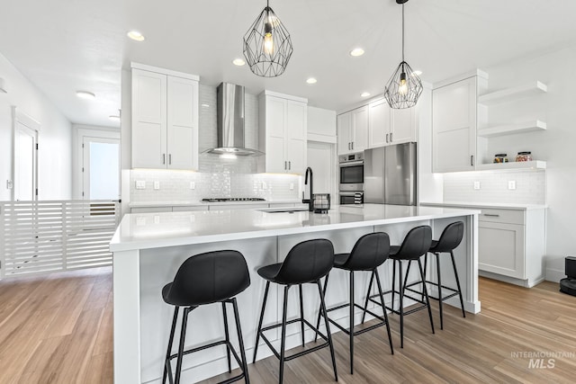 2398 N Klemmer Ave, Kuna, ID 83634 - kitchen with wall chimney exhaust hood, stainless steel appliances, open shelves, tasteful backsplash, and white cabinetry