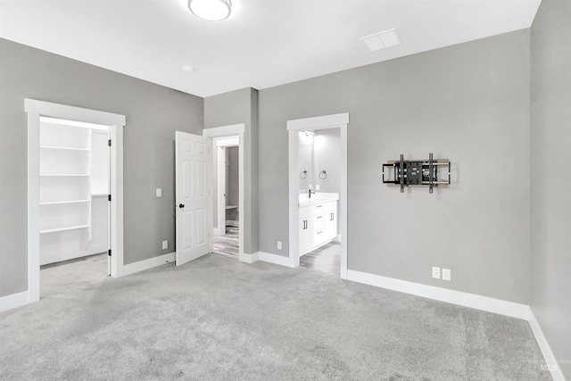680 E 19th St, Burley, ID 83318 - unfurnished bedroom with light colored carpet, a spacious closet, baseboards, and ensuite bathroom