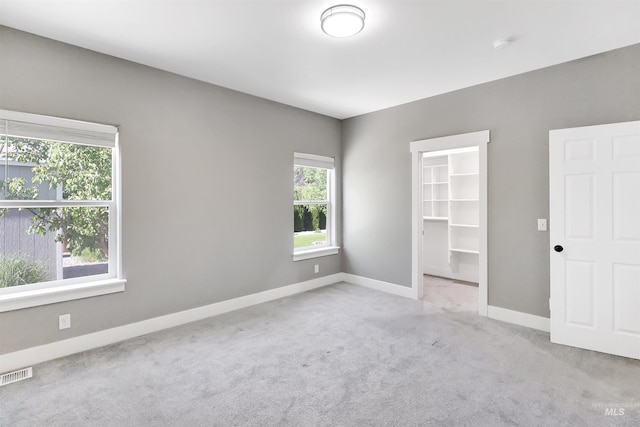 680 E 19th St, Burley, ID 83318 - unfurnished bedroom featuring a spacious closet, multiple windows, carpet floors, and baseboards