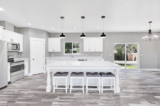 680 E 19th St, Burley, ID 83318 - kitchen featuring stainless steel appliances, light countertops, light wood-style floors, plenty of natural light, and recessed lighting