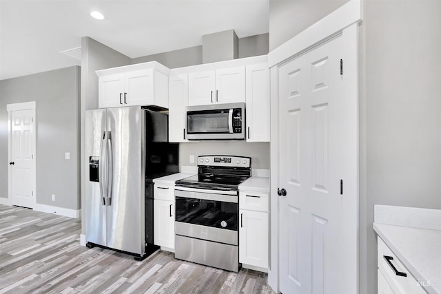 680 E 19th St, Burley, ID 83318 - kitchen featuring stainless steel appliances, light wood-type flooring, white cabinets, baseboards, and recessed lighting