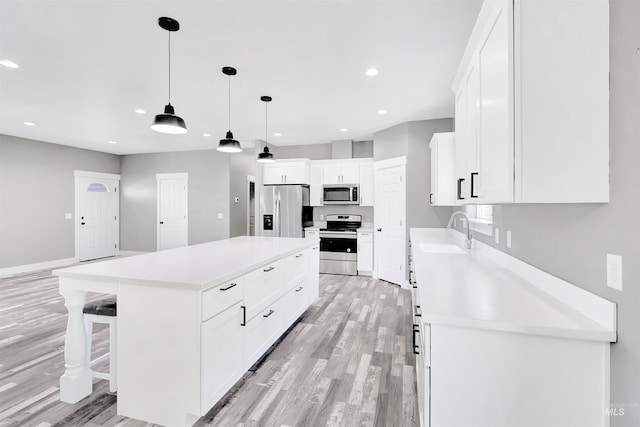 680 E 19th St, Burley, ID 83318 - kitchen featuring stainless steel appliances, a sink, light wood-style flooring, light countertops, and recessed lighting