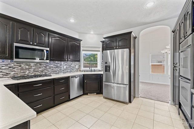 1992 S Elkhound Ave, Meridian, ID 83642 - kitchen featuring appliances with stainless steel finishes, light countertops, decorative backsplash, a sink, and recessed lighting