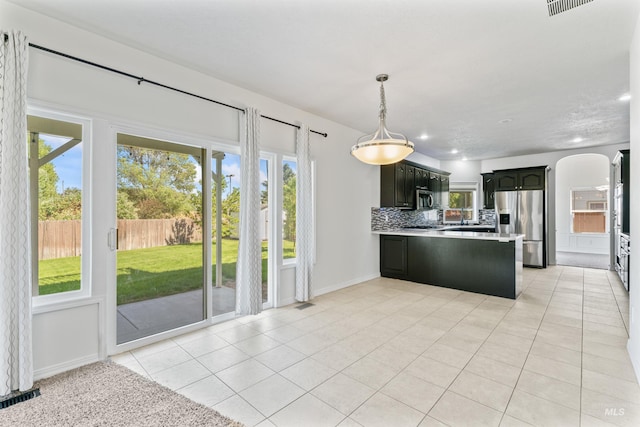 1992 S Elkhound Ave, Meridian, ID 83642 - kitchen featuring appliances with stainless steel finishes, light countertops, decorative backsplash, light tile patterned floors, and recessed lighting