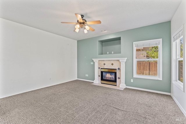 1992 S Elkhound Ave, Meridian, ID 83642 - unfurnished living room with carpet, a ceiling fan, a tiled fireplace, and baseboards