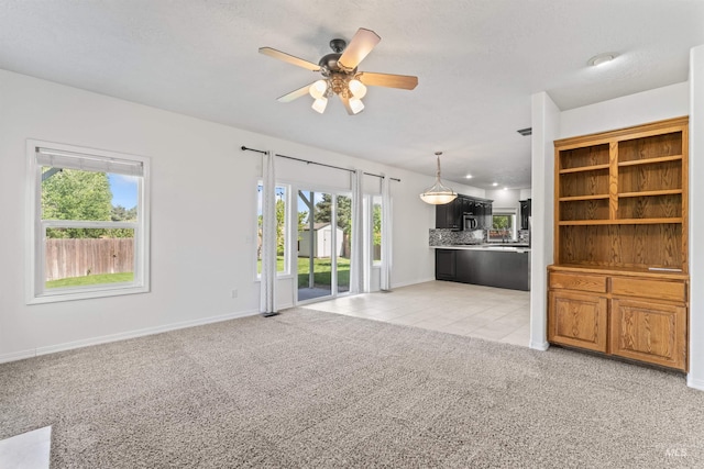 1992 S Elkhound Ave, Meridian, ID 83642 - unfurnished living room with ceiling fan, light carpet, baseboards, and light tile patterned flooring