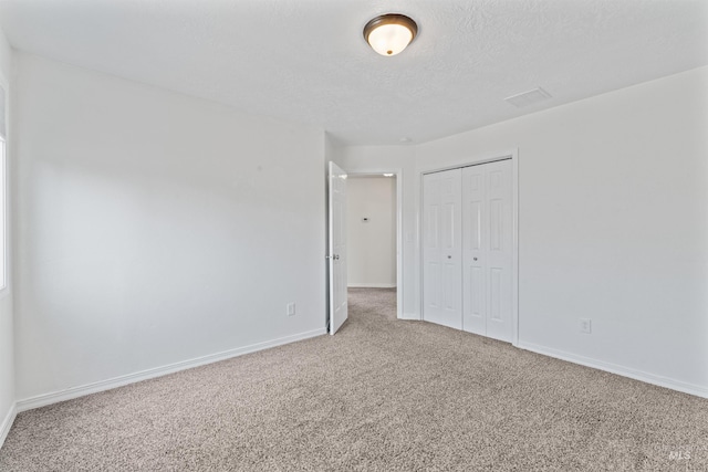 1992 S Elkhound Ave, Meridian, ID 83642 - unfurnished bedroom featuring carpet flooring, a closet, baseboards, and a textured ceiling