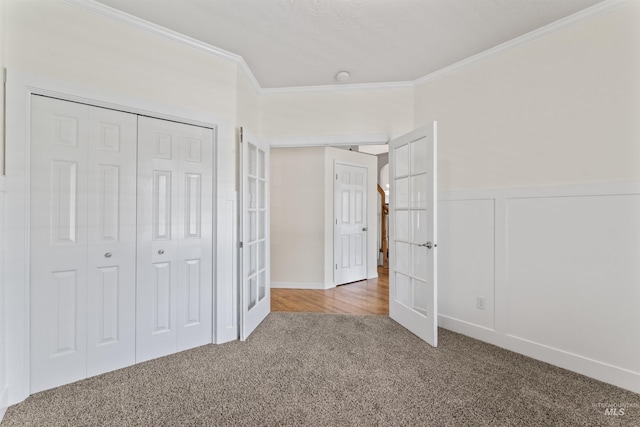 1992 S Elkhound Ave, Meridian, ID 83642 - unfurnished bedroom featuring crown molding, carpet flooring, a closet, and wainscoting