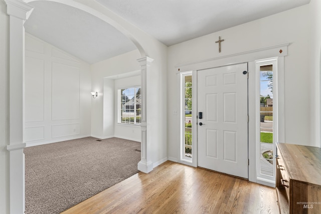 1992 S Elkhound Ave, Meridian, ID 83642 - entrance foyer with ornate columns, arched walkways, light wood-style floors, lofted ceiling, and baseboards