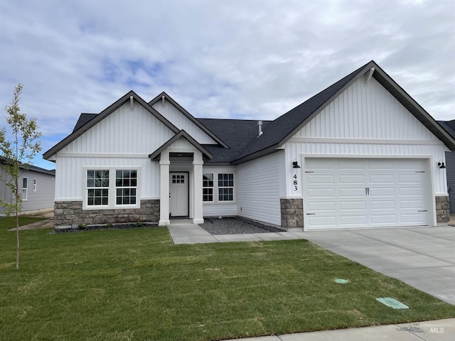 483 Hope Ave, Twin Falls, ID 83301 - view of front of home featuring board and batten siding, stone siding, an attached garage, and concrete driveway