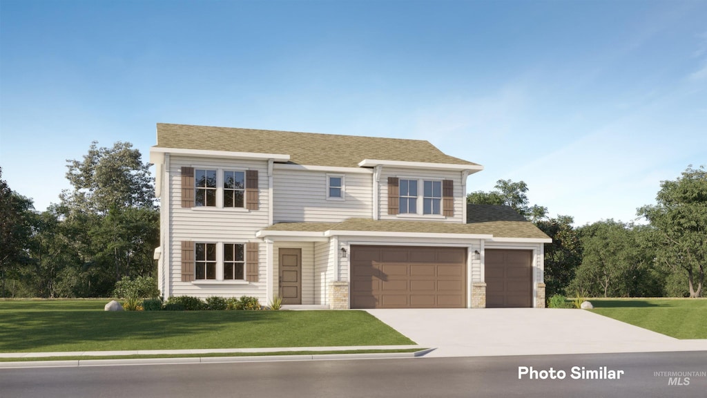 view of front of property with a front lawn and a garage