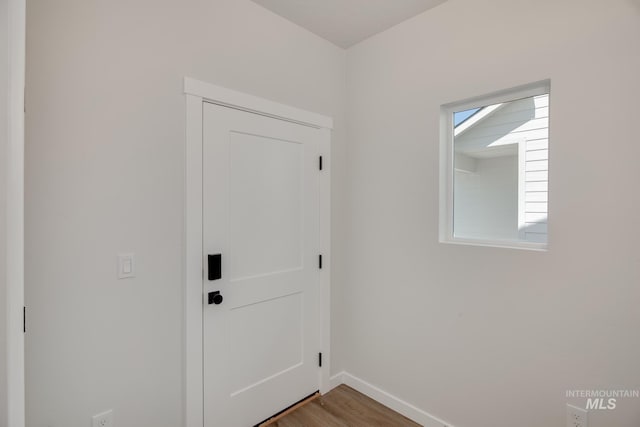 entryway featuring wood finished floors and baseboards