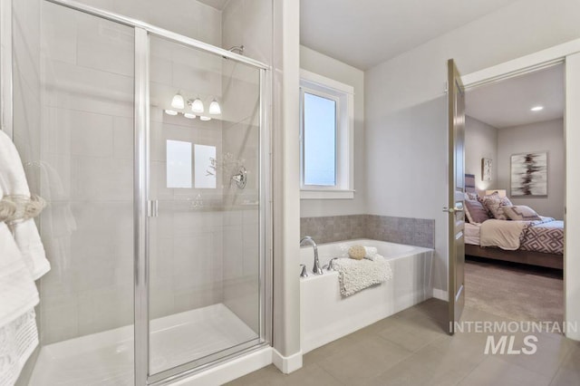 bathroom featuring plus walk in shower and tile patterned flooring