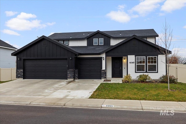 view of front of property featuring a garage and a front lawn