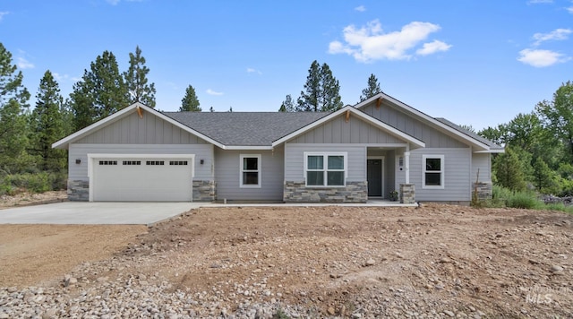207 Lainey Ln, Idaho City, ID 83631 - craftsman inspired home with board and batten siding, an attached garage, driveway, stone siding, and a shingled roof