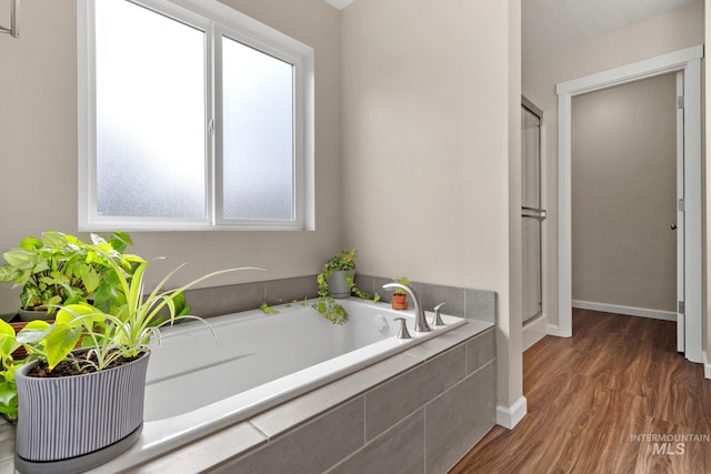 207 Lainey Ln, Idaho City, ID 83631 - full bathroom featuring a bath, wood finished floors, and a shower stall