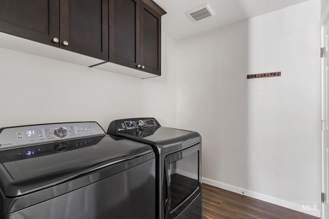 207 Lainey Ln, Idaho City, ID 83631 - laundry room with cabinet space, washer and clothes dryer, and dark wood-style floors