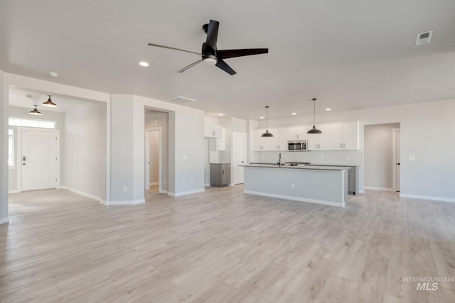 unfurnished living room with light wood-style floors, recessed lighting, visible vents, and a ceiling fan