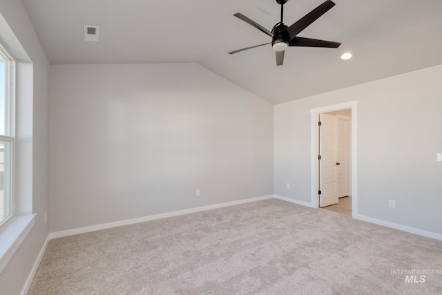 unfurnished room featuring lofted ceiling, baseboards, a wealth of natural light, and recessed lighting