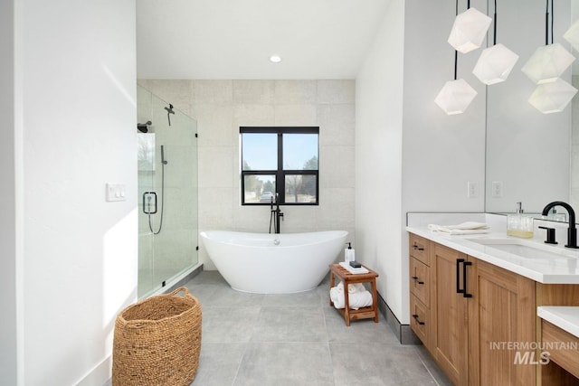 bathroom with vanity and independent shower and bath