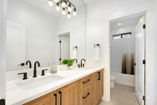 full bathroom featuring tile patterned flooring, shower / bath combination with curtain, vanity, and toilet