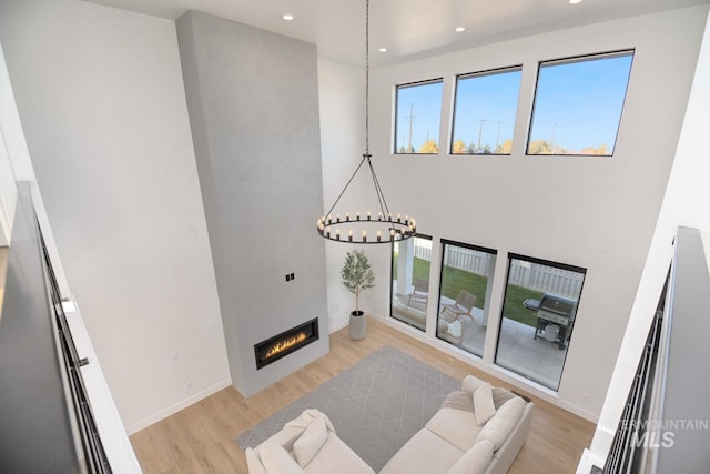 living room with a notable chandelier and light hardwood / wood-style flooring