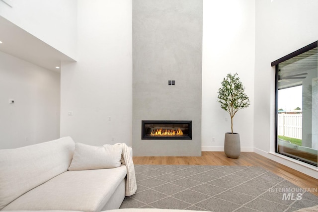 living room with a large fireplace and light hardwood / wood-style floors