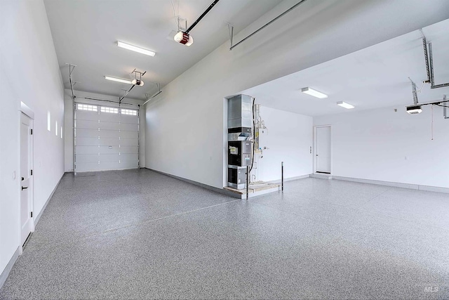 garage with a garage door opener and baseboards