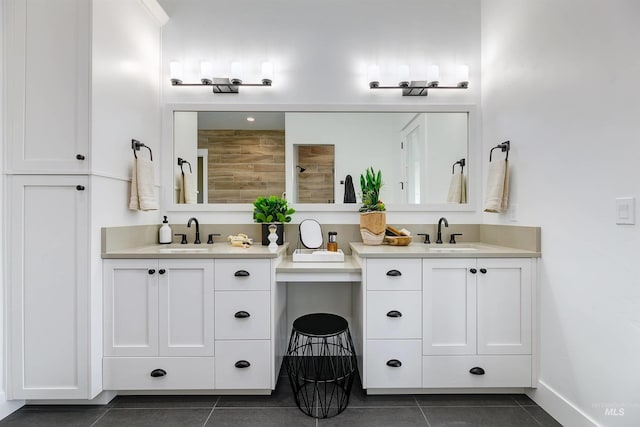bathroom featuring tile patterned floors, two vanities, and a tile shower