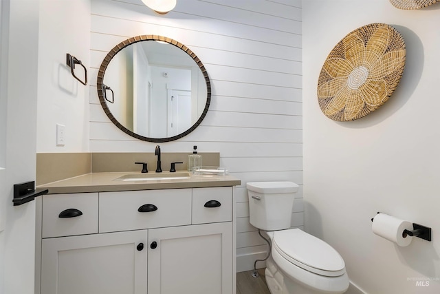 bathroom featuring toilet and vanity