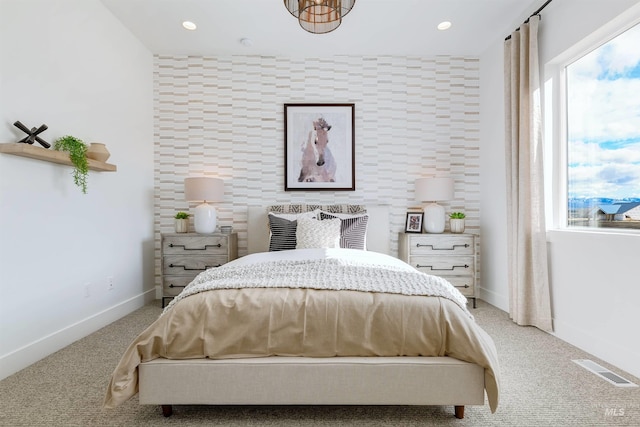bedroom with multiple windows, light carpet, an accent wall, baseboards, and recessed lighting