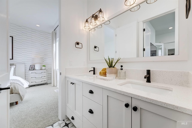 bathroom featuring double vanity, ensuite bath, and recessed lighting